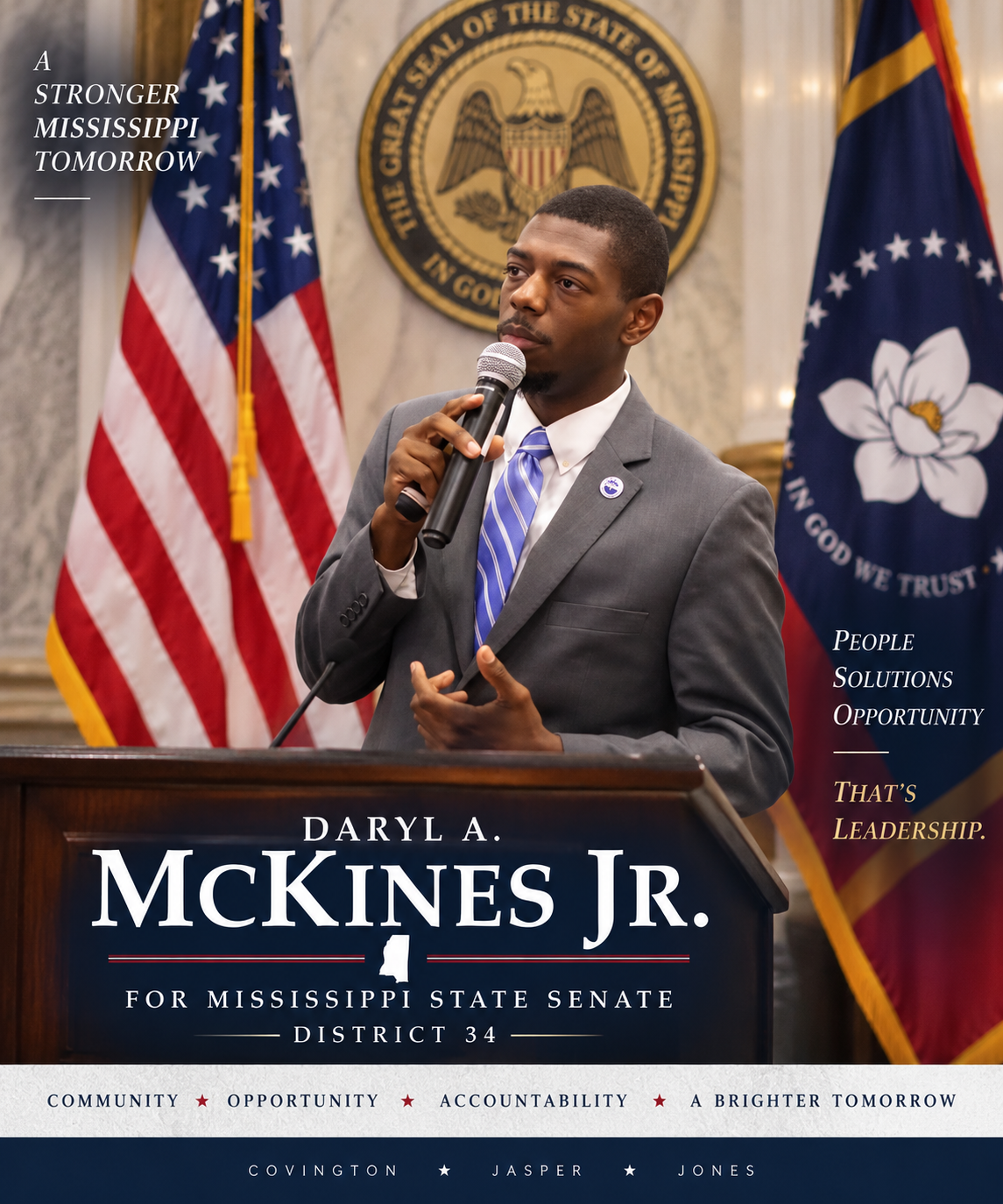 Daryl A. McKines Jr. speaking at a podium with the United States and Mississippi flags behind him